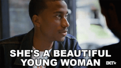 Man Sitting In Front Of Window Saying She's A Beautiful Young Woman GIF
