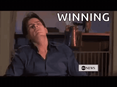 Man Sitting In Front Of Winning Sign GIF