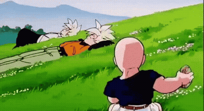 Man Sitting In Grass Looking At Lying Man GIF