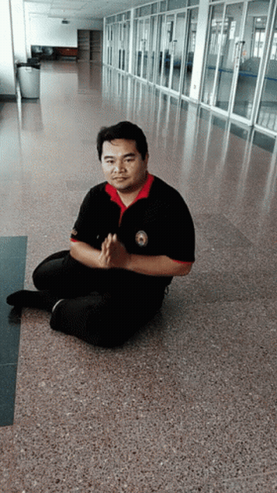 Man Sitting In Hallway With Folded Hands GIF