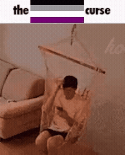 Man Sitting In Hammock Looking At Cell Phone GIF