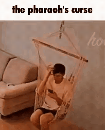 Man Sitting In Hammock Looking At Phone GIF