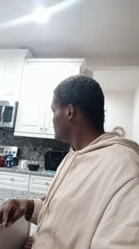 Man Sitting In Kitchen Looking GIF