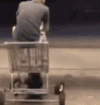 Man Sitting In Shopping Cart On Beach GIF
