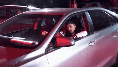 Man Sitting In Silver Car With M On Side GIF