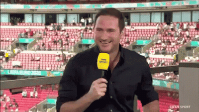 Man Sitting In Stadium Holding Microphone GIF