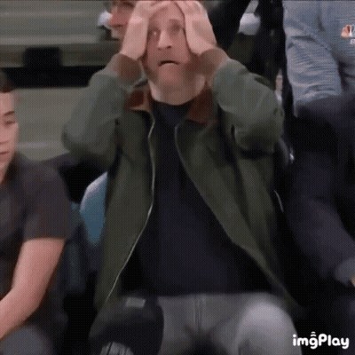Man Sitting In Stadium With Hands On Head Surprised GIF