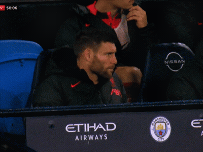 Man Sitting In Stadium With Nissan Logo GIF