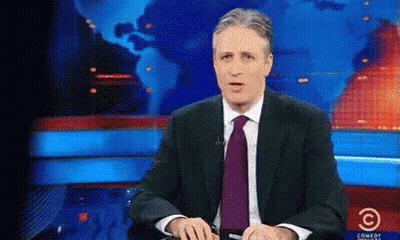 Man Sitting In Suit And Tie At Comedy Central Screen GIF