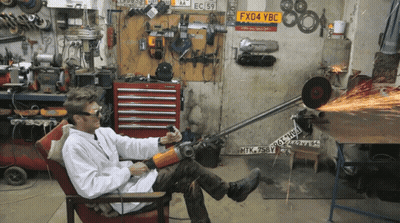 Man Sitting in Workshop With License Plate FX04 YBC