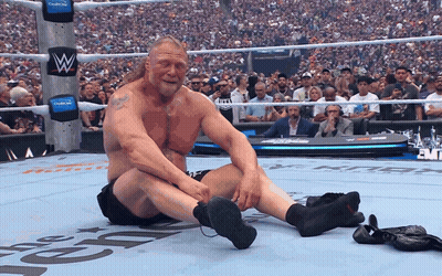 Man Sitting In Wrestling Ring With Letter W GIF