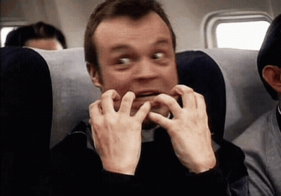 Man Sitting On Airplane Making Funny Face GIF