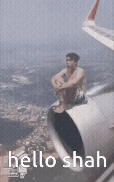Man Sitting On Airplane Wing Saying Hello Shah GIF