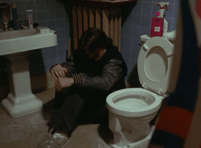 Man Sitting On Bathroom Floor Next To Toilet And Soap Spray Bottle GIF