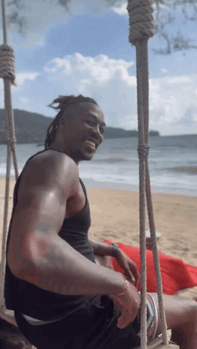 Man Sitting On Beach Swing Smiling GIF