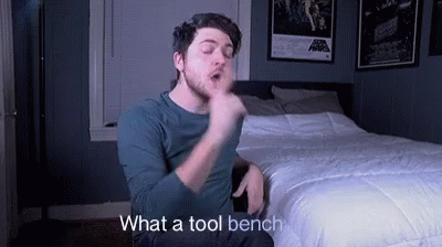 Man Sitting On Bed Making Funny Face GIF