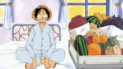 Man Sitting On Bed Next To Box Of Fruit GIF