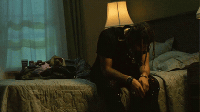 Man Sitting On Bed With Head Down GIF