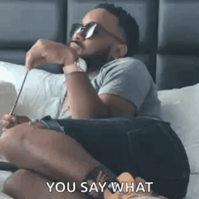 Man Sitting On Bed With Sunglasses And Pencil GIF