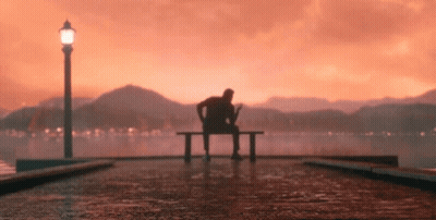 Man Sitting On Bench By Water GIF