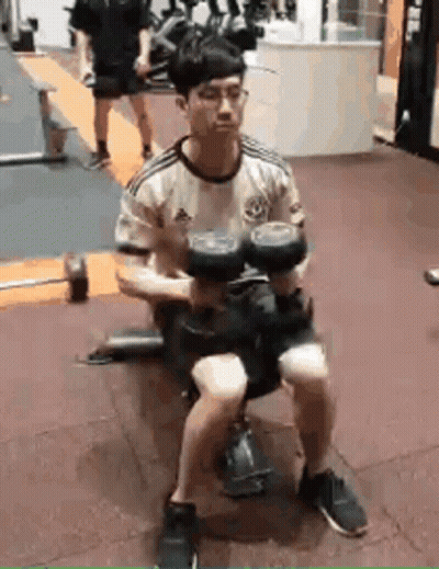 Man Sitting On Bench Holding Dumbbell GIF