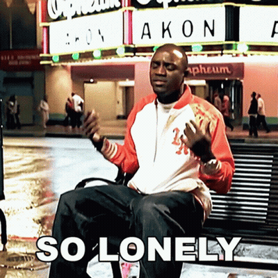 Man Sitting On Bench In Front Of Akon Sign GIF