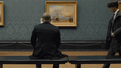 Man Sitting On Bench In Front Of Painting GIF