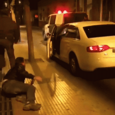 Man Sitting On Bench Next To White Car GIF