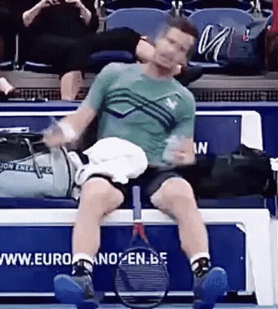 Man Sitting On Bench With Tennis Racquet GIF
