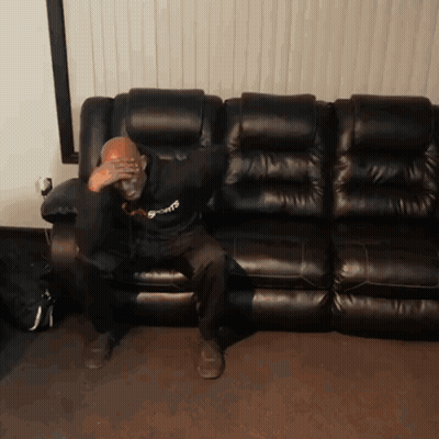 Man Sitting On Black Leather Couch GIF