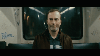 Man Sitting On Bus With Graffiti GIF