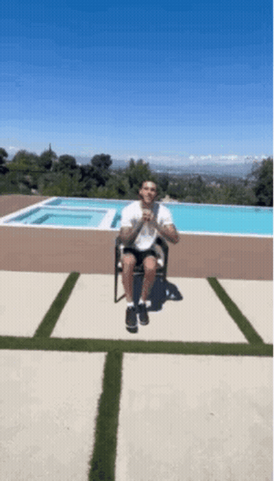 Man Sitting On Chair In Front Of Pool GIF