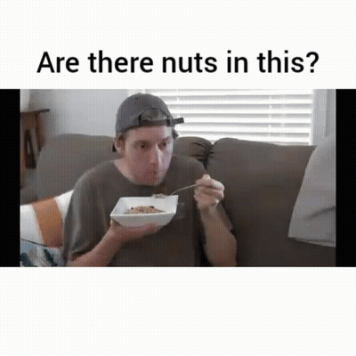 Man Sitting On Couch Eating Cereal GIF
