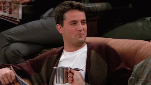 Man Sitting On Couch Holding Cup Of Coffee GIF