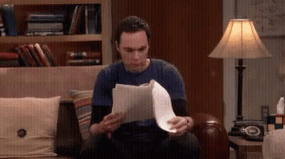Man Sitting On Couch Holding Paper GIF