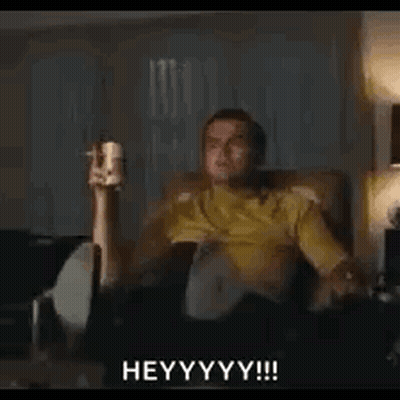 Man Sitting On Couch Holding Remote And Beer GIF