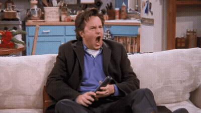 Man Sitting on Couch Holding Remote