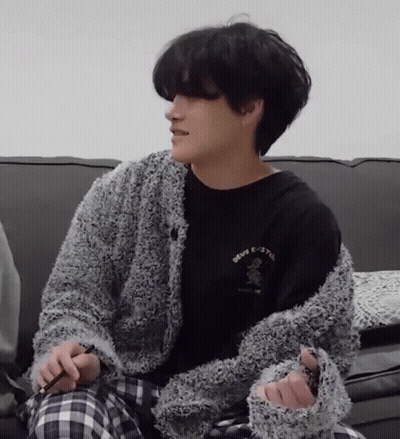 Man Sitting On Couch In Black Shirt And Gray Sweater GIF