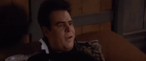 Man Sitting On Couch In Dark Room Talking GIF