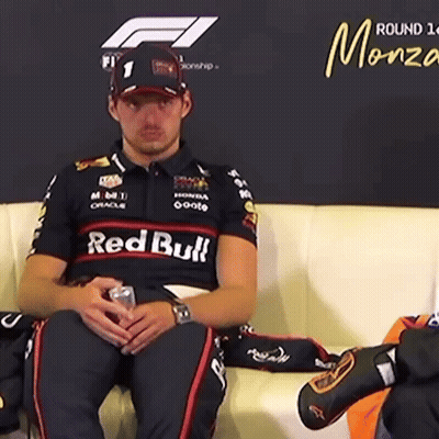 Man Sitting on Couch in Red Bull Shirt