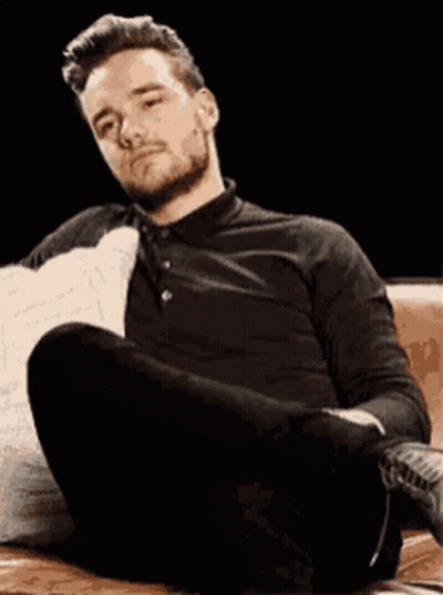 Man Sitting On Couch Legs Crossed Head Down GIF