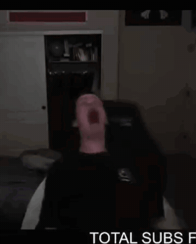 Man Sitting On Couch Mouth Open Dark Room Total Subs GIF