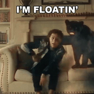 Man Sitting On Couch Next To Black Panther Says I'm Floatin GIF