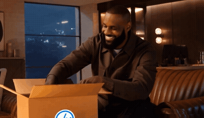 Man Sitting On Couch Opening Box With Blue Circle GIF
