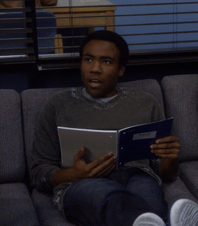 Man Sitting On Couch Reading Book Am I Using That Right GIF