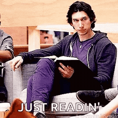 Man Sitting On Couch Reading Book GIF