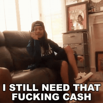Man Sitting On Couch Saying I Still Need That Fucking Cash GIF