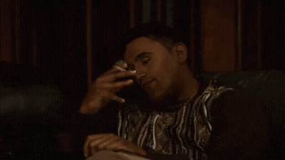 Man Sitting On Couch Smoking Cigarette GIF