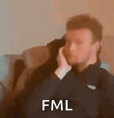 Man Sitting On Couch Talking On Phone Saying FML GIF