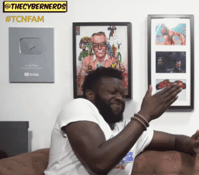 Man Sitting On Couch Under Tcnfam Sign GIF